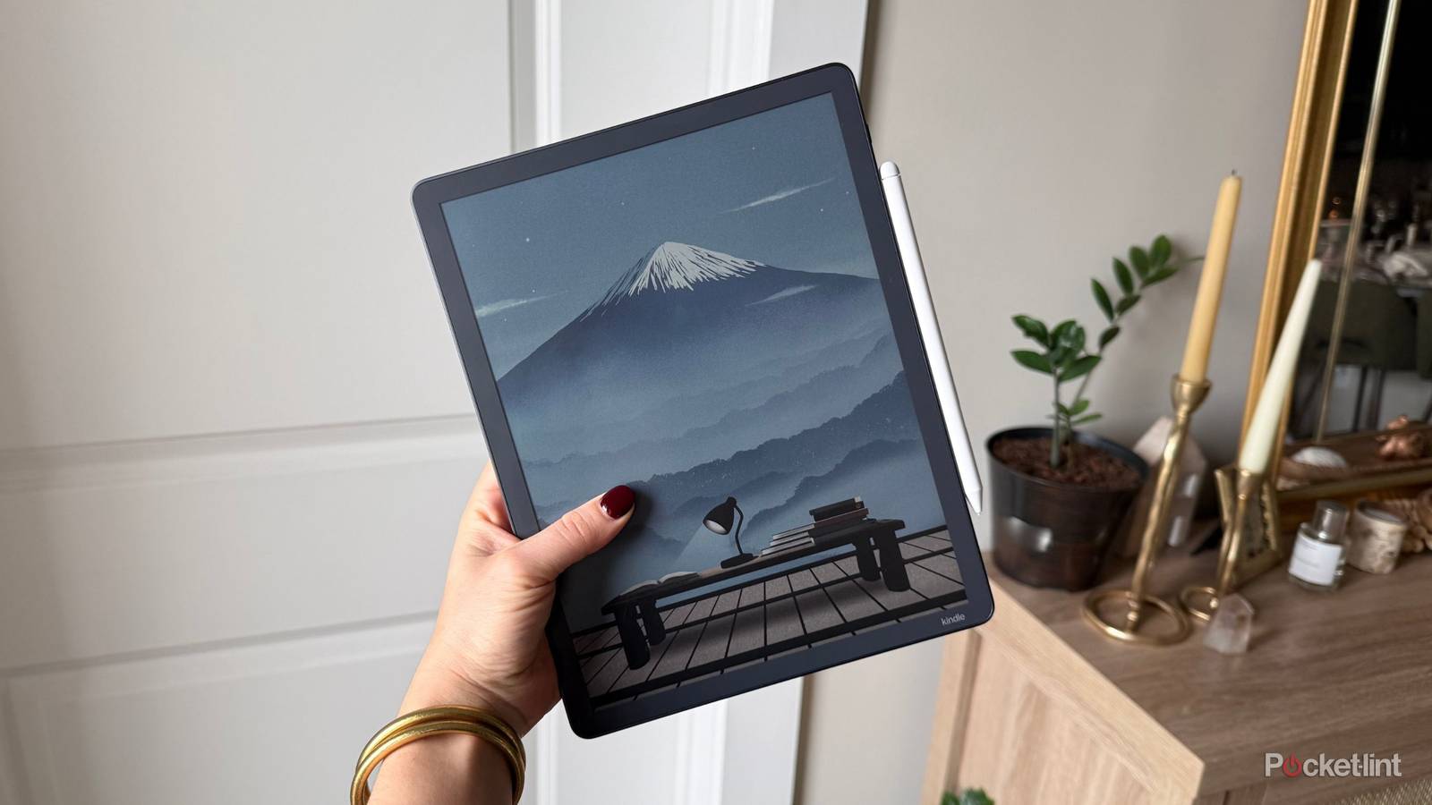 The Kindle Scribe Colorsoft with a mountain. 