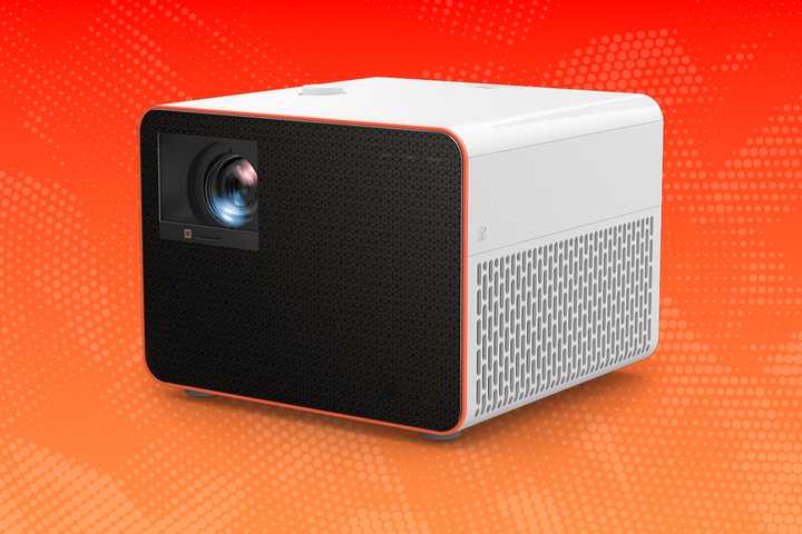 A projector on an orange background. 