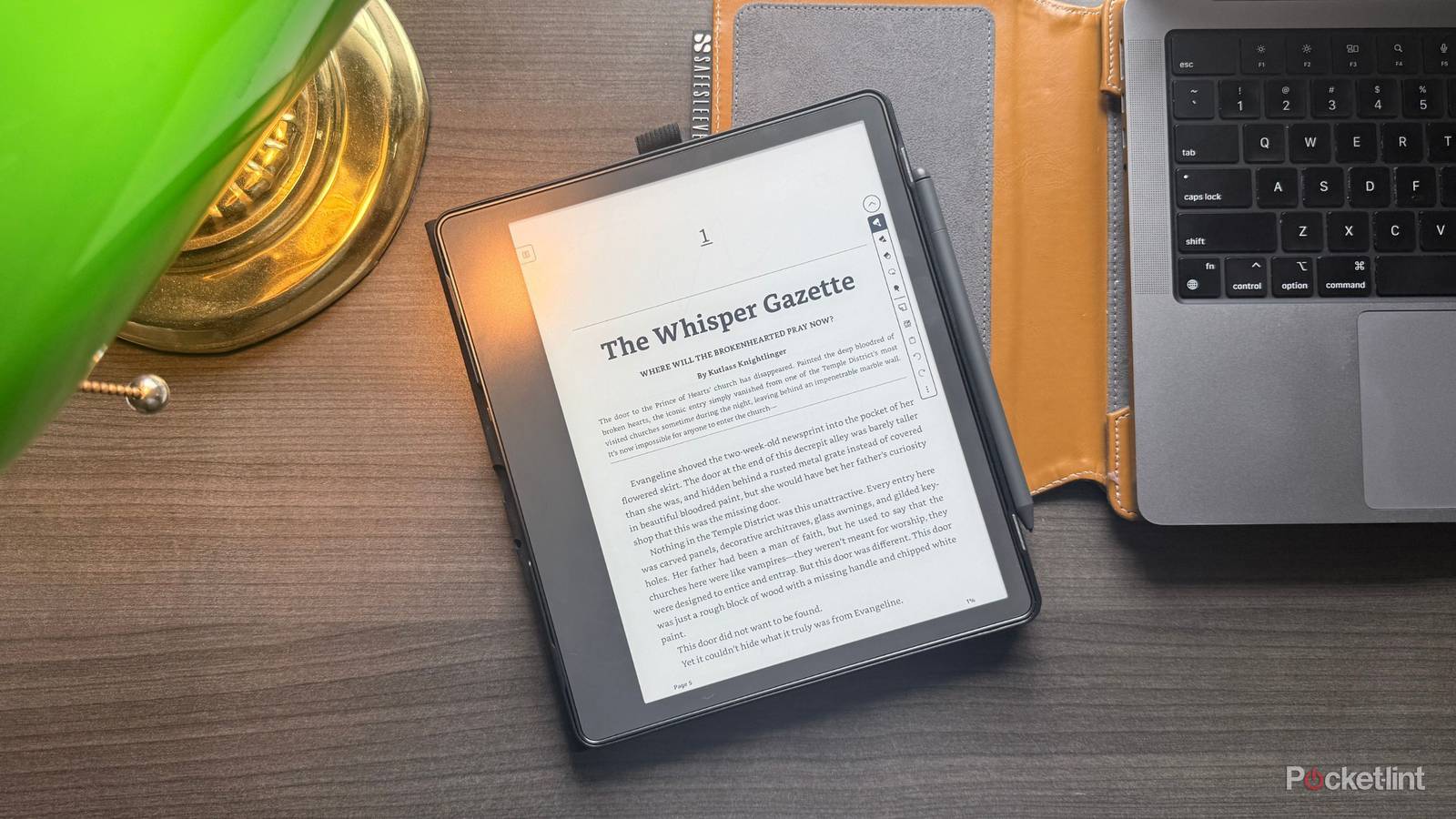 A Kindle Scribe and banker's lamp. 