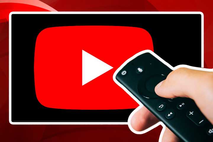 Person holding TV remote in front of TV with YouTube app on it.